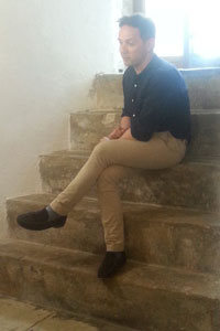 Iestyn Davies sitting on the steps at the Martello Tower, Landmark Trust