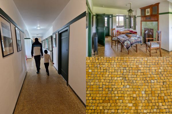 People walking down a corridor with yellow mosaic tiles