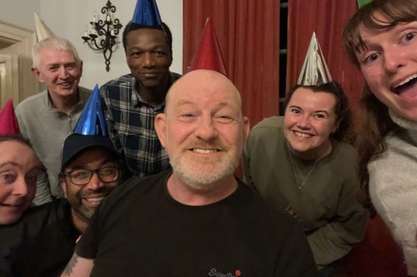 A group of people wearing party hats