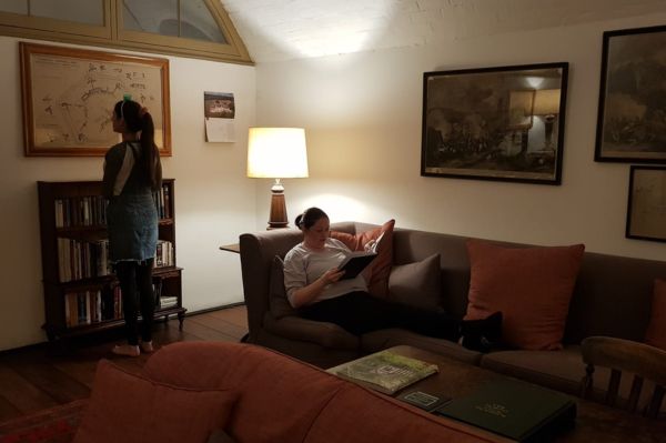 Guests sitting on the sofa and admiring artwork on the wall