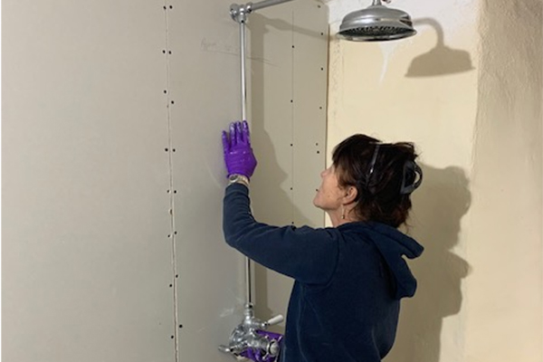 Jane Yelland installing the new shower at Priests House