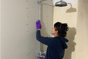 Jane Yelland installing the new shower at Priests House