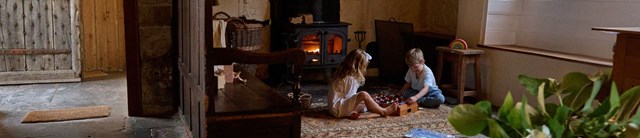 Kids playing in front of a cosy stove