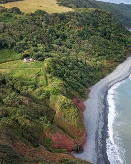 An aerial view of a cabin by the sea
