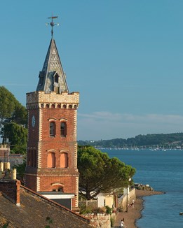 A red brick tower on a river estuary