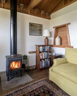 A cosy sitting room with log burning stove
