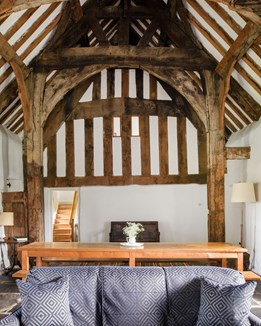 Interior of a great timber framed hall with a sofa