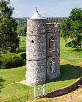 A small Victorian lodge surrounded by trees