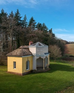 A woodland cottage surrounded by trees