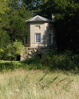 A Georgian folly standing in woodlands and fields