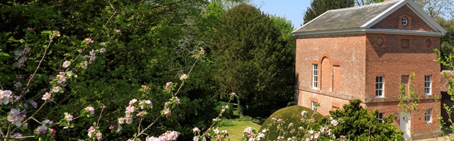 A georgian hunting lodge, with blossom in the foreground