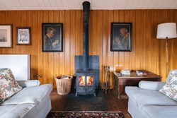 Arra Venton interior sitting with stove1200x800