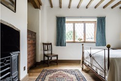 Bromfield Priory Gatehouse int double with fireplace1200x800