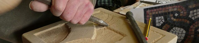 A piece of stone being hand chiseled 