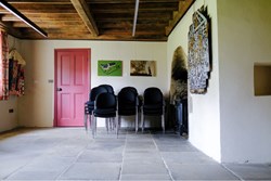 Calverley Old Hall Community Space fireplace end with  chairs stacked 1200x800