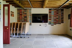 Calverley Old Hall Community Space TV end with chairs stacked 1200x800