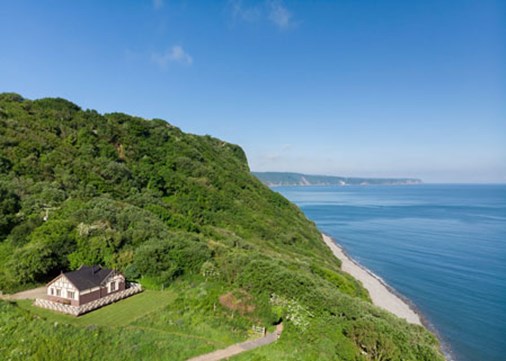 peppercombe-castle-bungalow-exterior-drone-main-450x321