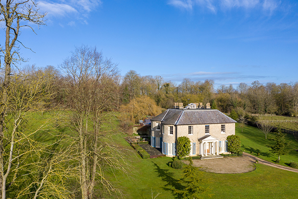 Cavendish Hall surrounded by rolling hills and trees