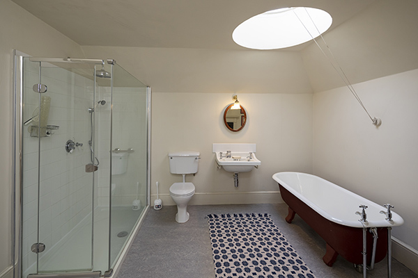 Bathroom with shower, standalone bath and circular skylight