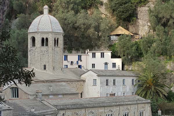 Historic domed building on a hill surrounded by trees