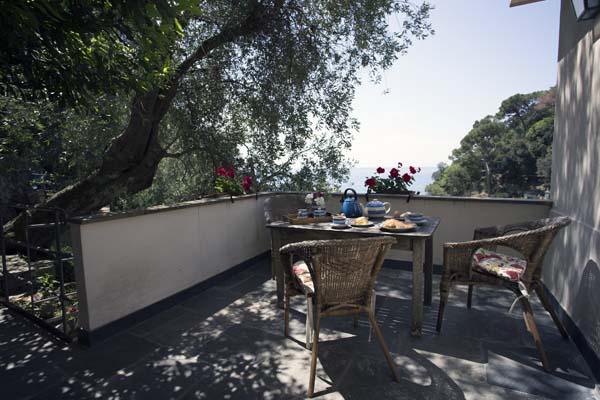 Terrace with table and chairs laid for breakfast
