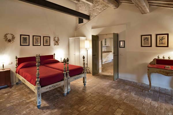 Bedroom with ornamental twin beds and ceiling beams