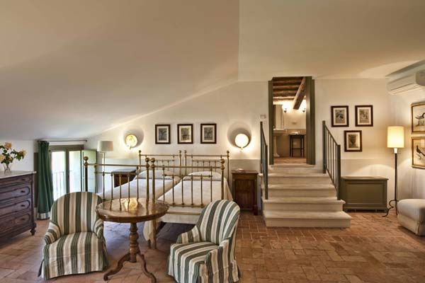 Bedroom with iron framed twin beds and four steps up to hallway 