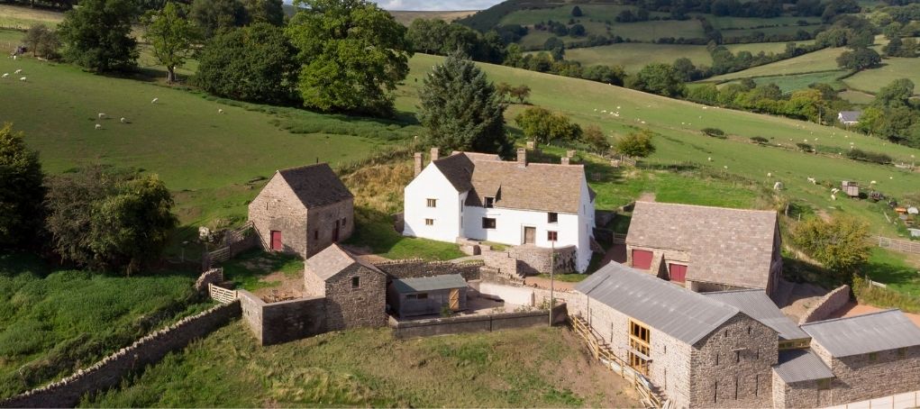 Aerial view of newly restored white-washed farm houses