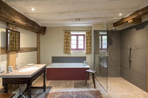 Bathroom with bath and separate walk-in shower and window with views over countryside