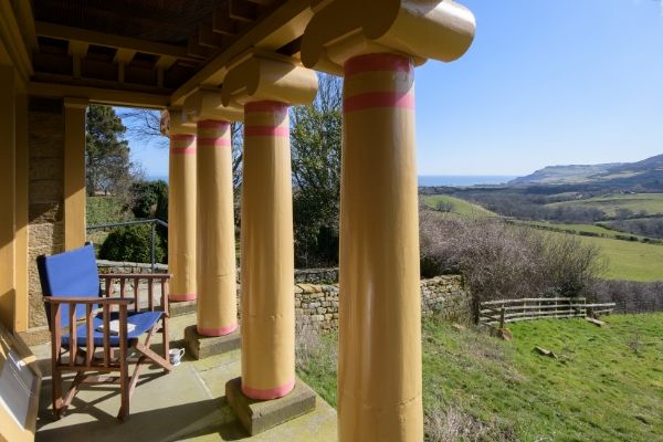 The view from the colonnaded terrace at The Pigsty across the hills to the sea