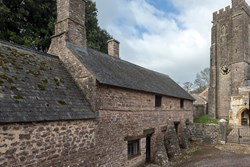 priests house external with church 1200x800