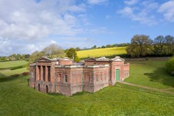 A red brick building with green doors
