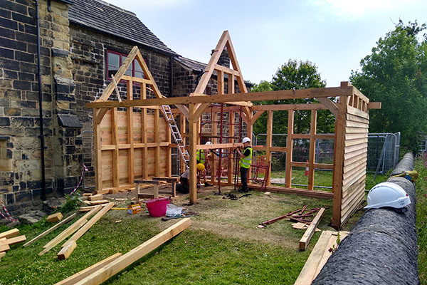 Calverley Old Hall SWAP Week 2 - timber frame construction with roof trusses almost on