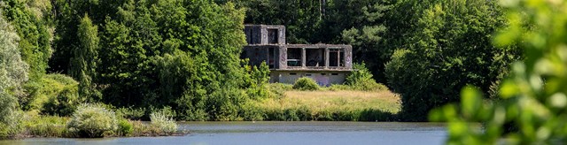 Derelict RAF Ibsley watch office across the lake