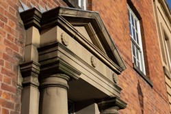 A yellow stone ornate doorway arch
